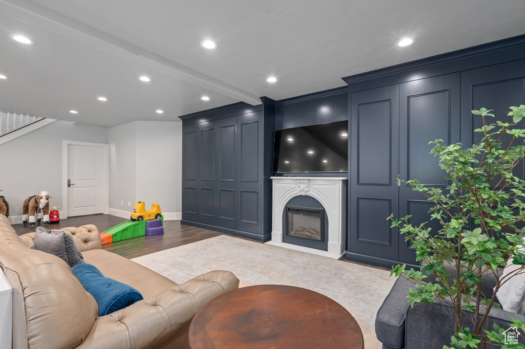 Living room featuring hardwood / wood-style floors and beam ceiling