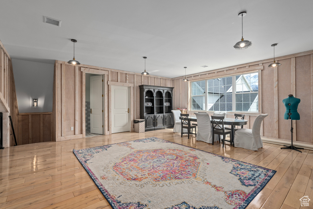 Living room featuring wood-type flooring and wooden walls