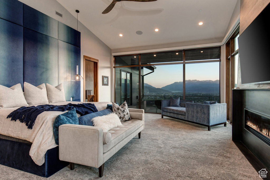 Bedroom with a mountain view, ceiling fan, carpet floors, and access to exterior