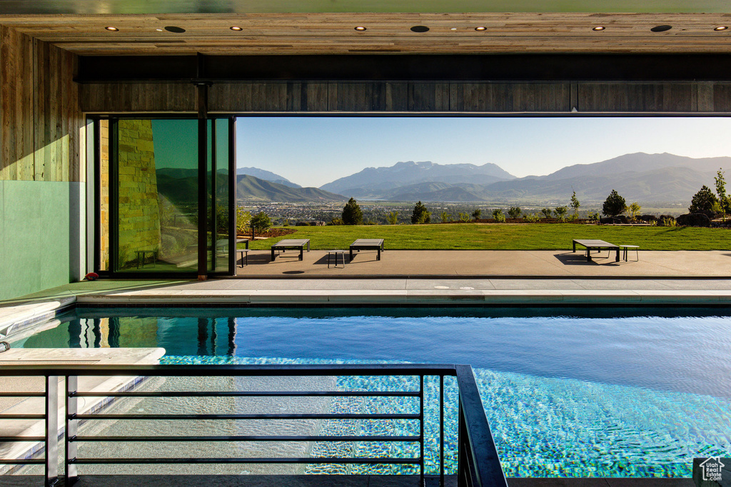 View of pool featuring a patio and a mountain view