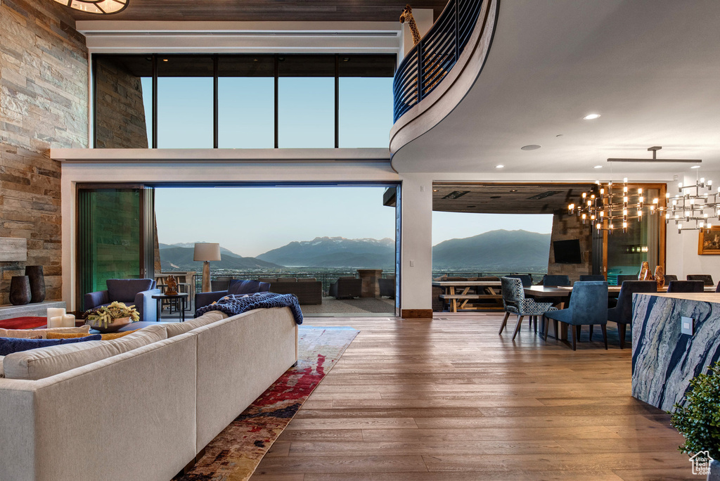 Living room with wood-type flooring, a mountain view, and a chandelier