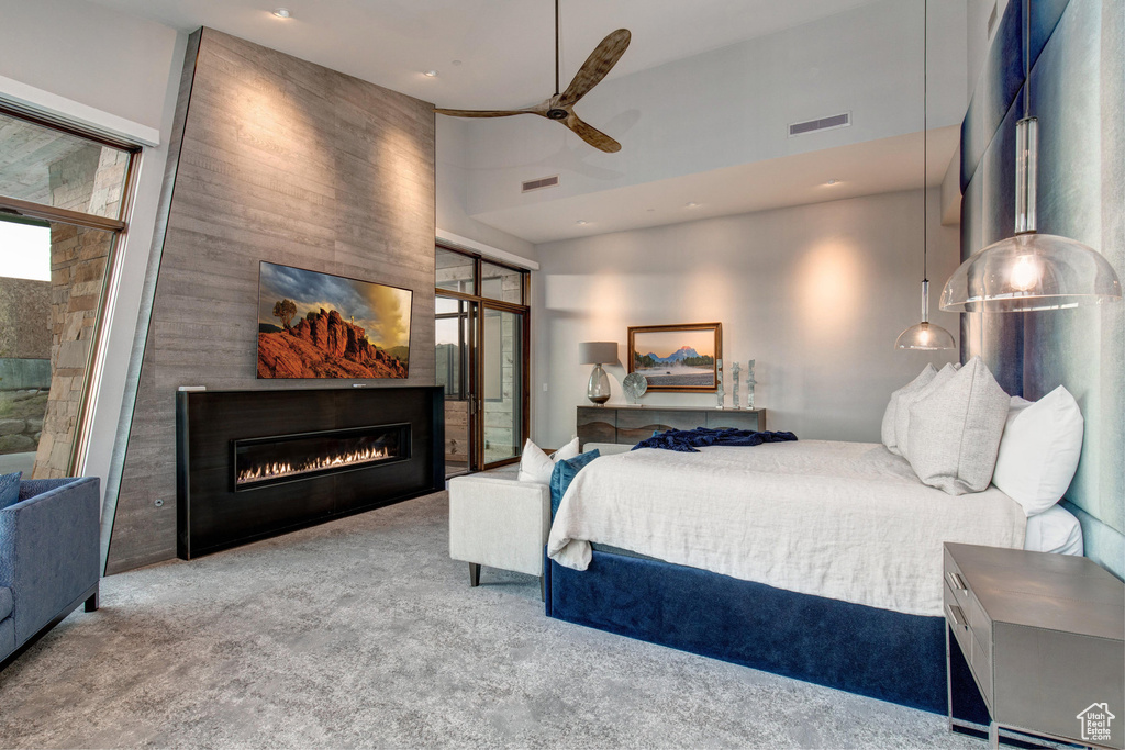 Carpeted bedroom featuring a towering ceiling and ceiling fan