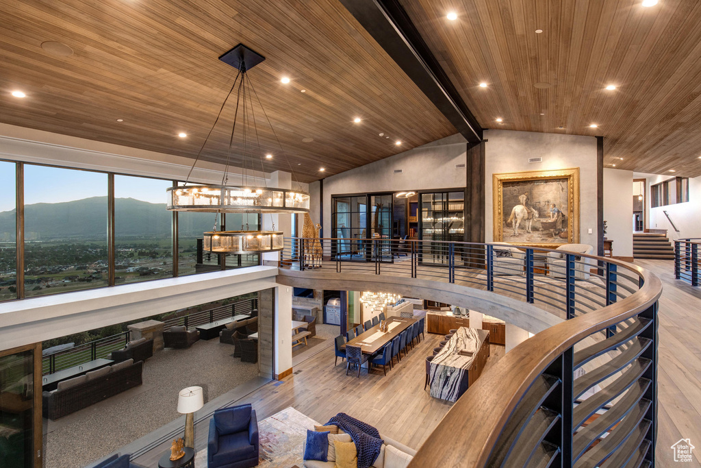 Dining area with high vaulted ceiling, a mountain view, hardwood / wood-style floors, and wooden ceiling