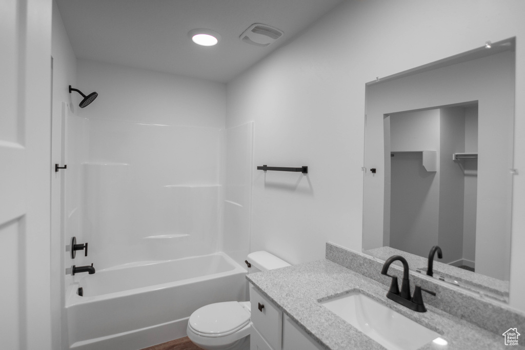 Full bathroom featuring vanity, toilet, and bathtub / shower combination