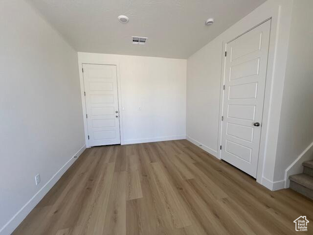 Spare room with hardwood / wood-style floors