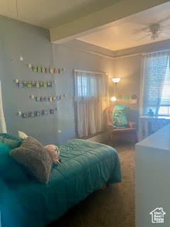 Bedroom featuring beam ceiling and carpet floors