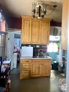 Kitchen with a chandelier and sink