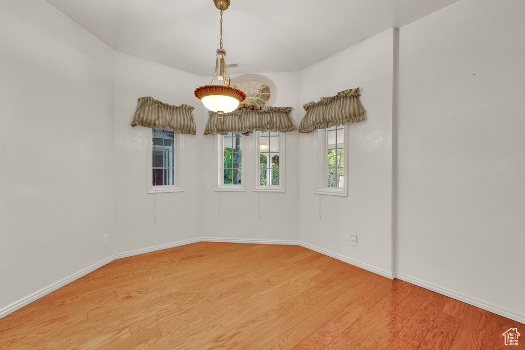 Unfurnished room with hardwood / wood-style flooring