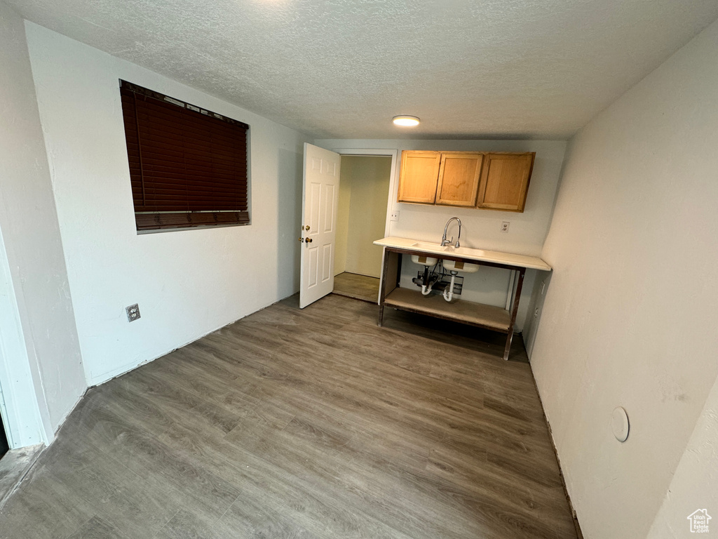 Interior space with a textured ceiling and dark hardwood / wood-style flooring