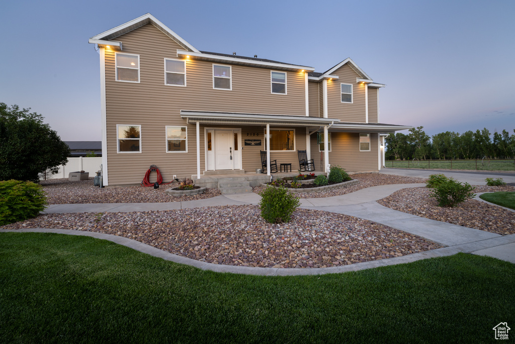 View of front of home featuring a porch and a front yard