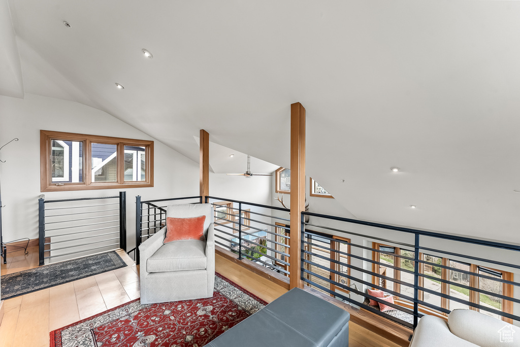 Living area with ceiling fan, vaulted ceiling, and hardwood / wood-style floors