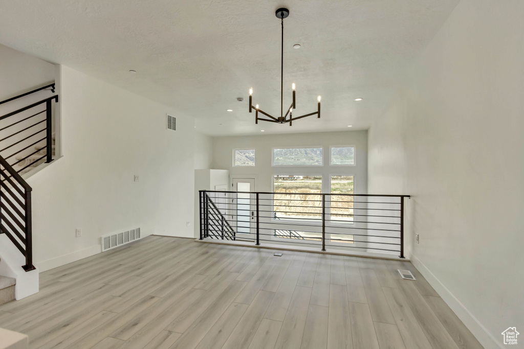 Interior space featuring a chandelier and light wood-type flooring