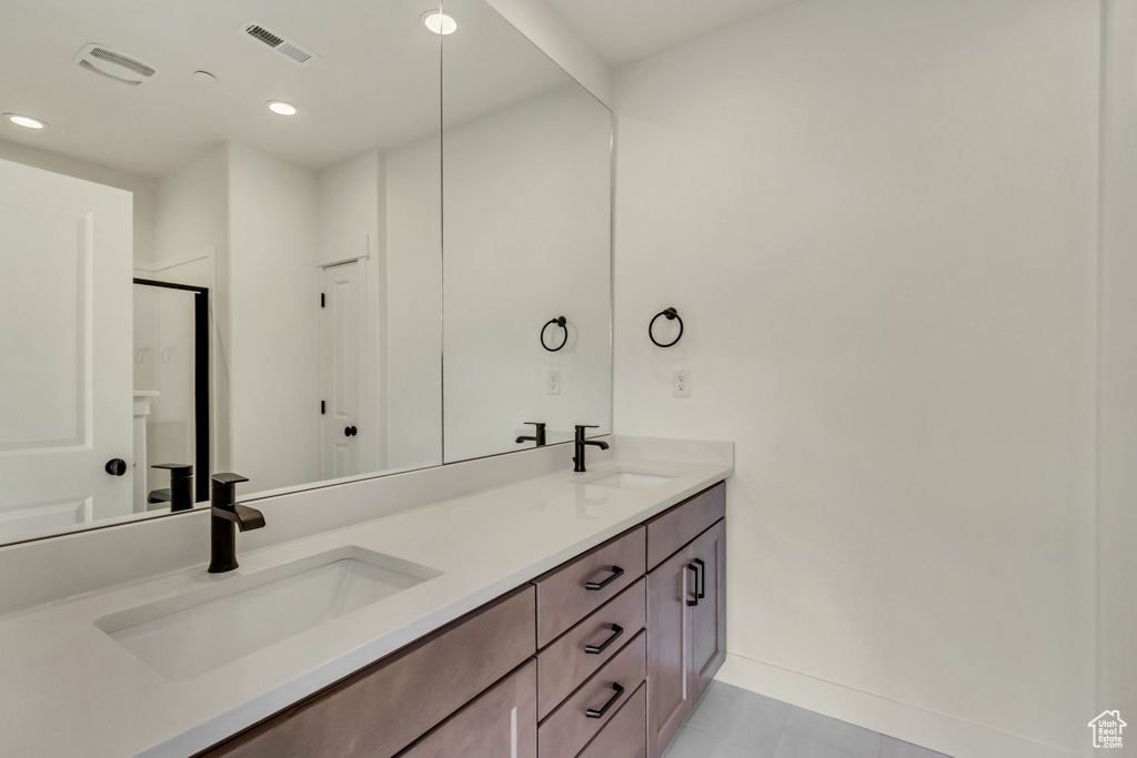 Bathroom with tile floors, double sink, and oversized vanity