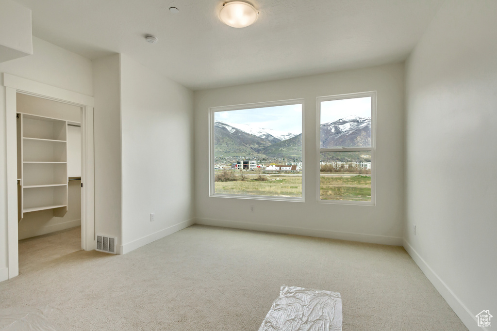 Carpeted spare room with a wealth of natural light