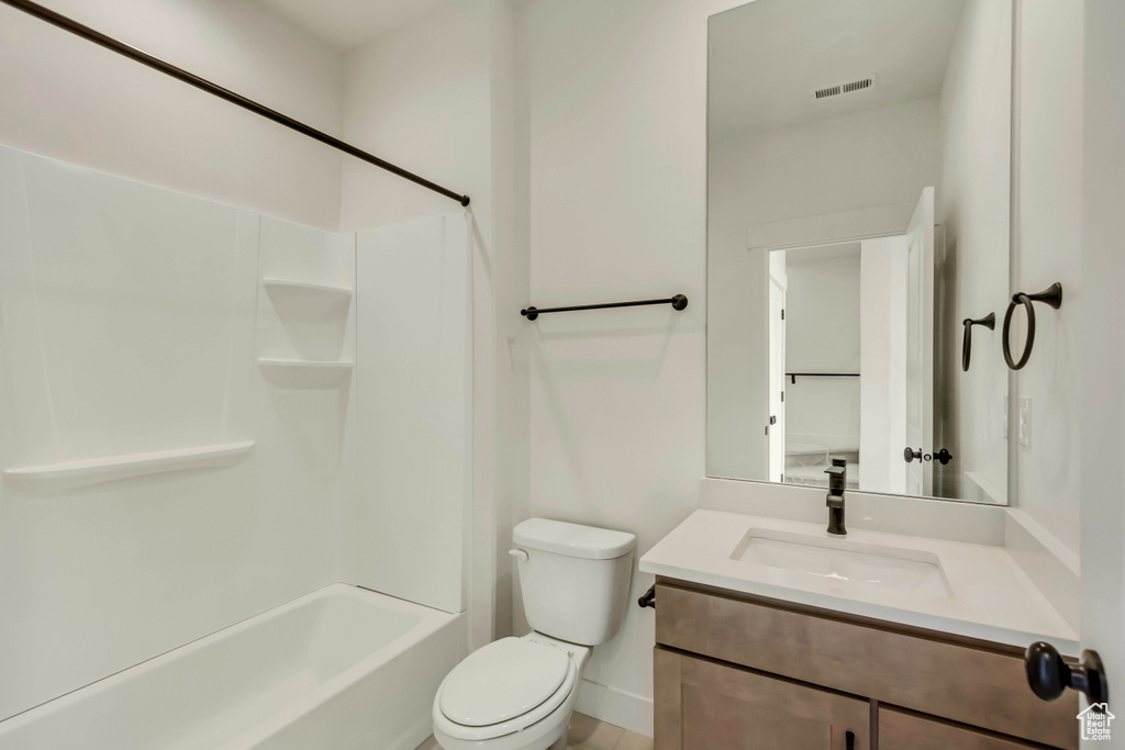 Full bathroom featuring bathtub / shower combination, vanity, and toilet