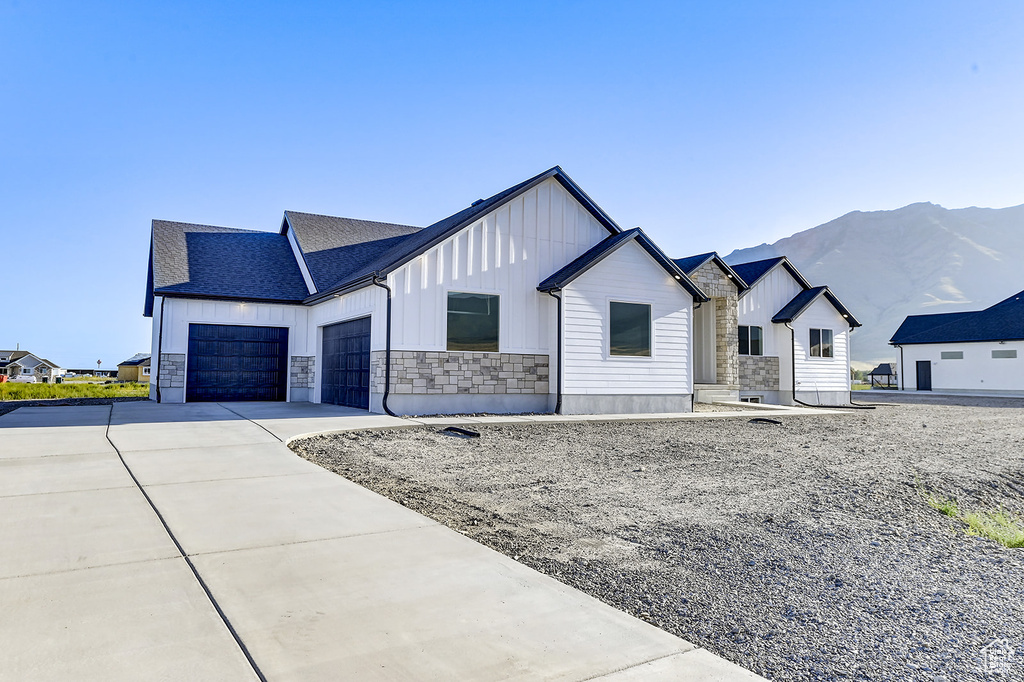 Modern farmhouse style home featuring a mountain view and a garage