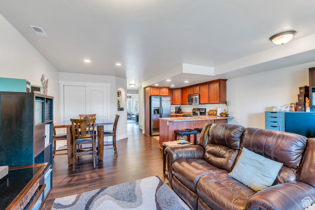 Living room with dark hardwood / wood-style flooring