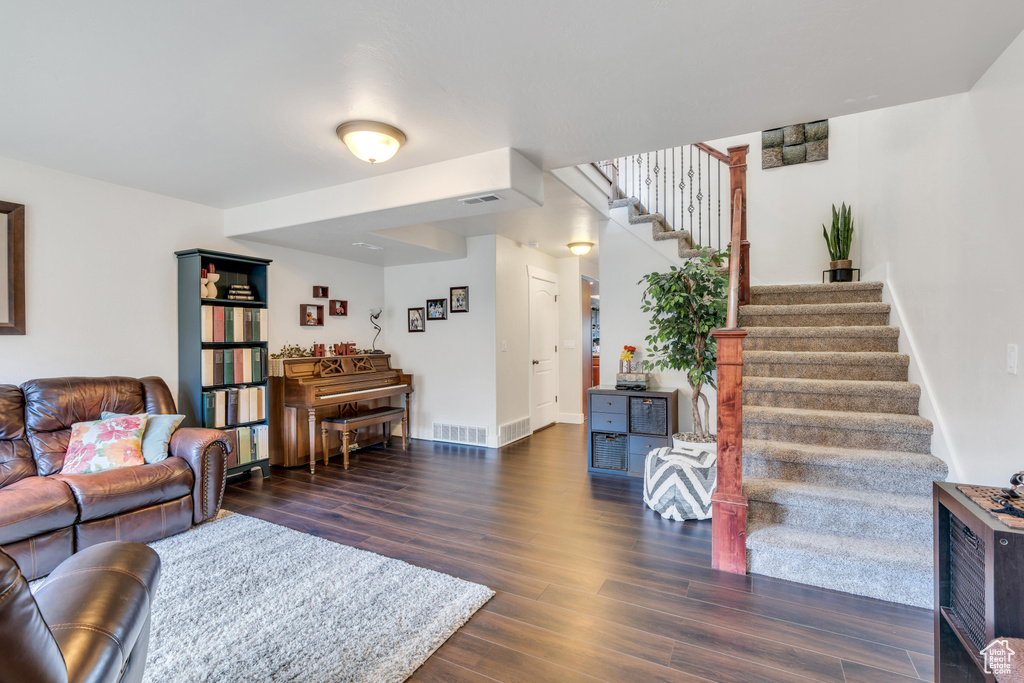 Living room with dark hardwood / wood-style flooring