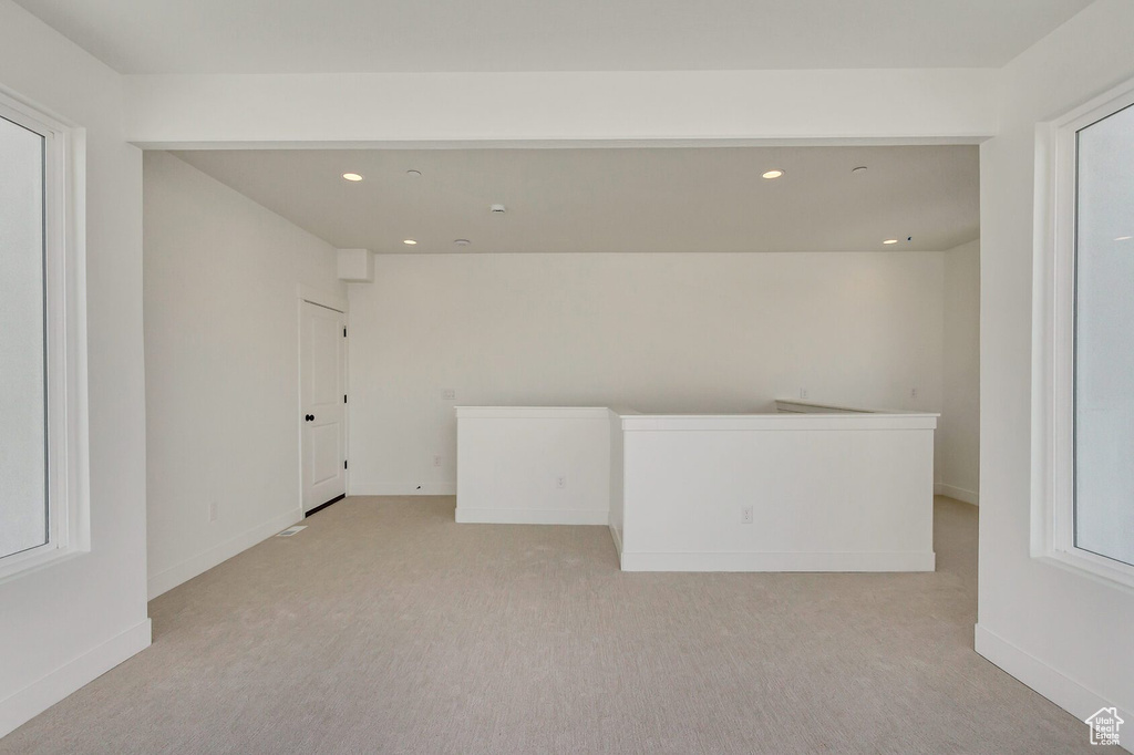 Carpeted empty room featuring a healthy amount of sunlight