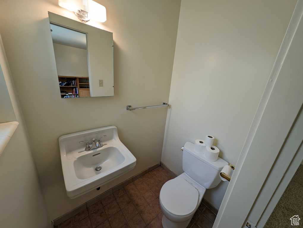 Bathroom with sink, toilet, and tile patterned flooring