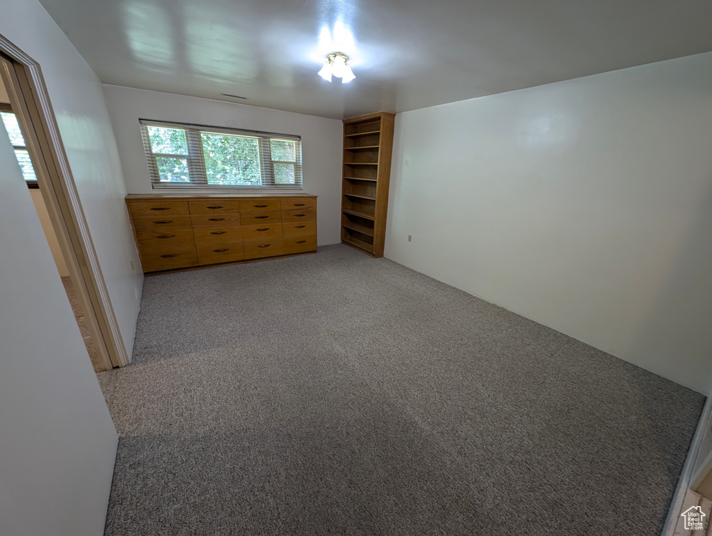 Unfurnished bedroom featuring light carpet