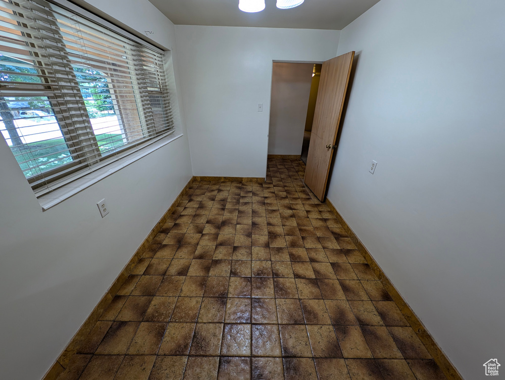 Hallway featuring dark tile patterned floors