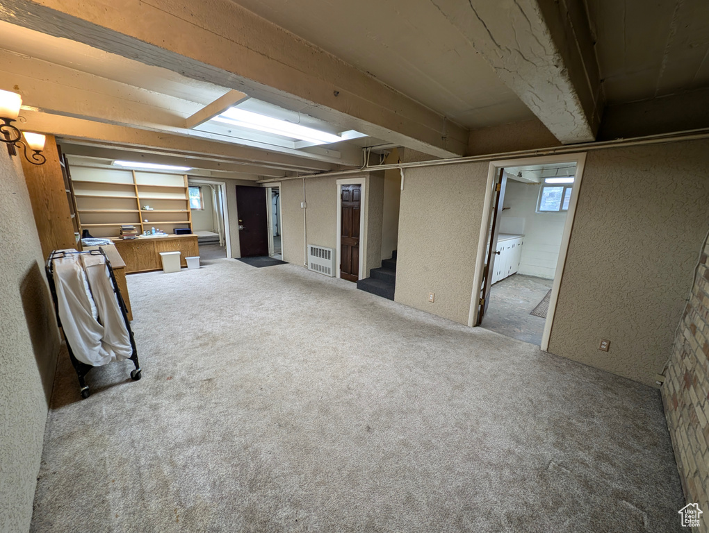 Unfurnished living room featuring light carpet