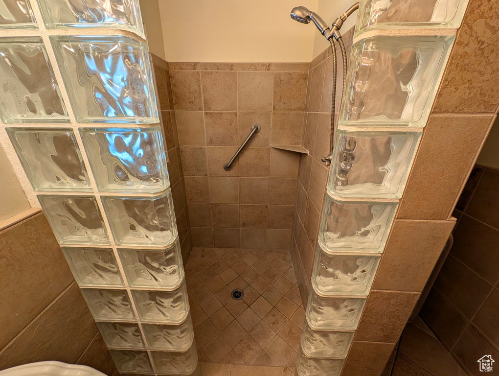 Bathroom featuring tile walls and a tile shower