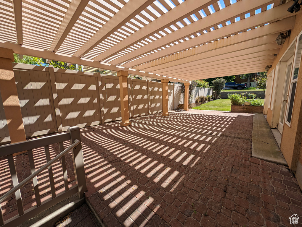 Deck featuring a pergola and a patio