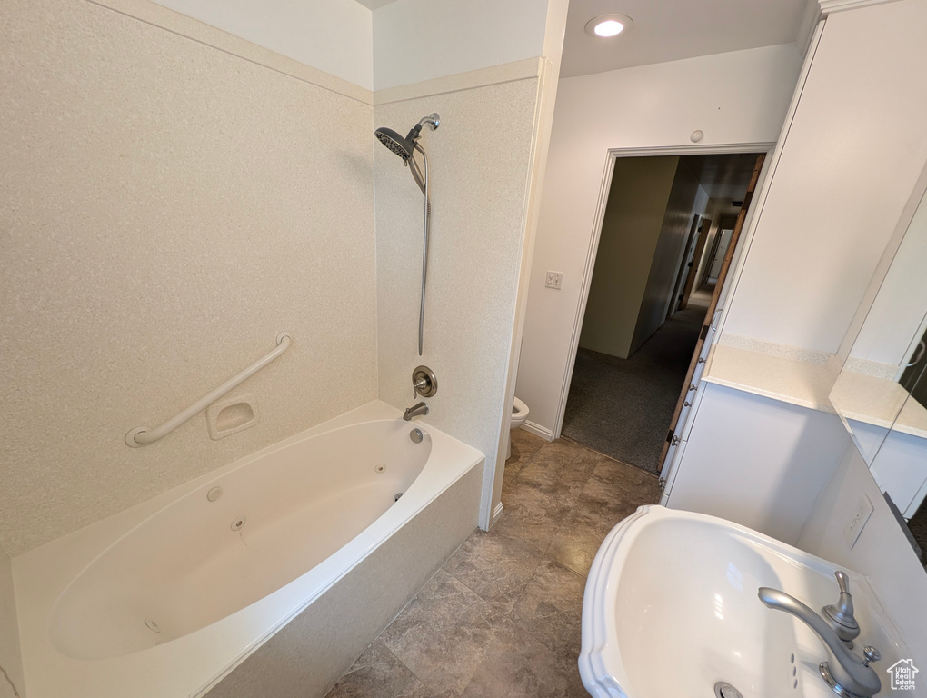 Full bathroom with sink, bathing tub / shower combination, toilet, and tile patterned floors