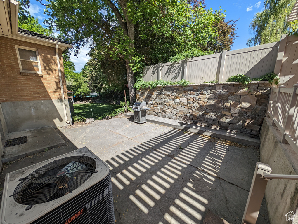 View of patio / terrace featuring central air condition unit and a grill