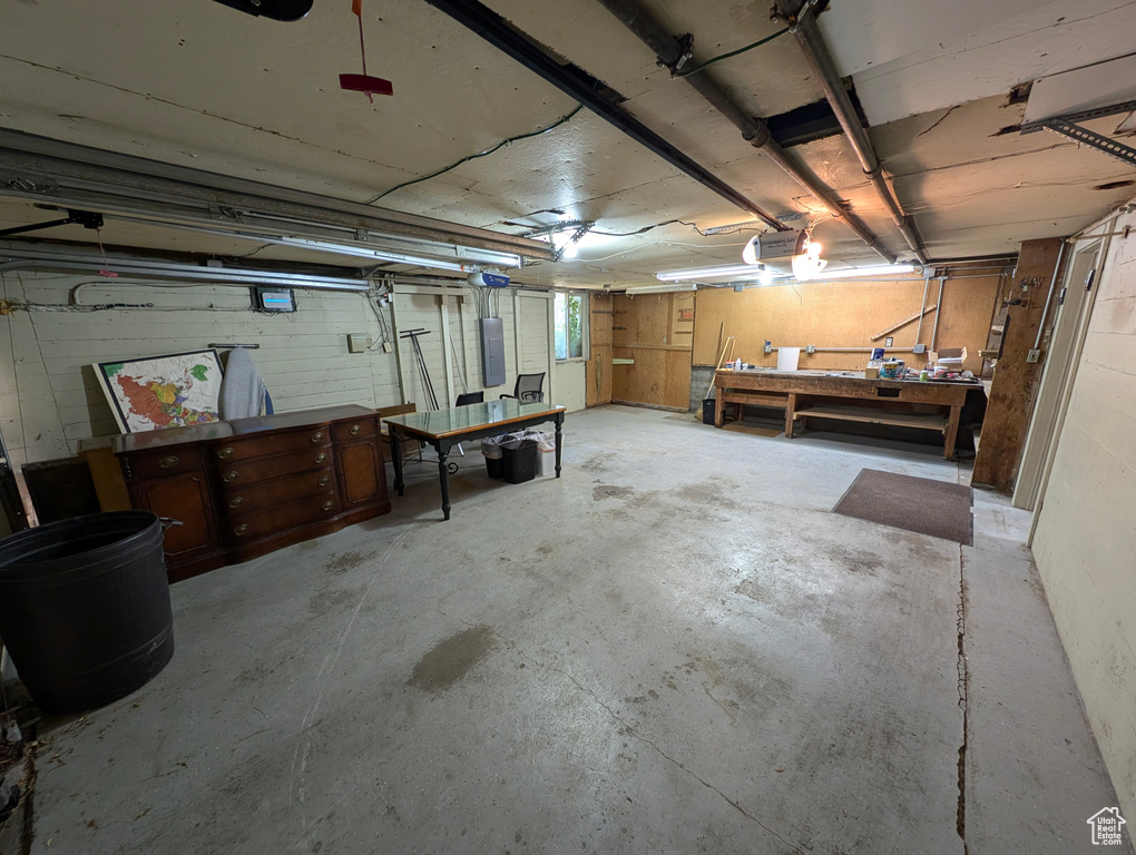 Basement with a workshop area and electric panel