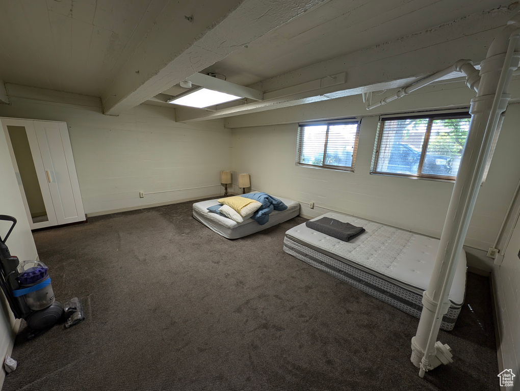 Miscellaneous room featuring carpet and beamed ceiling