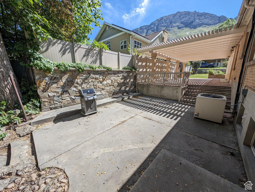 View of patio with a mountain view and a pergola