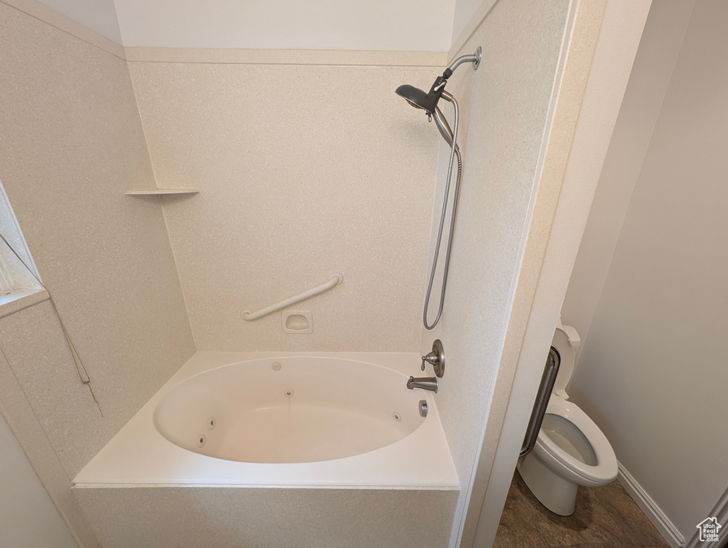 Bathroom featuring shower / washtub combination and toilet