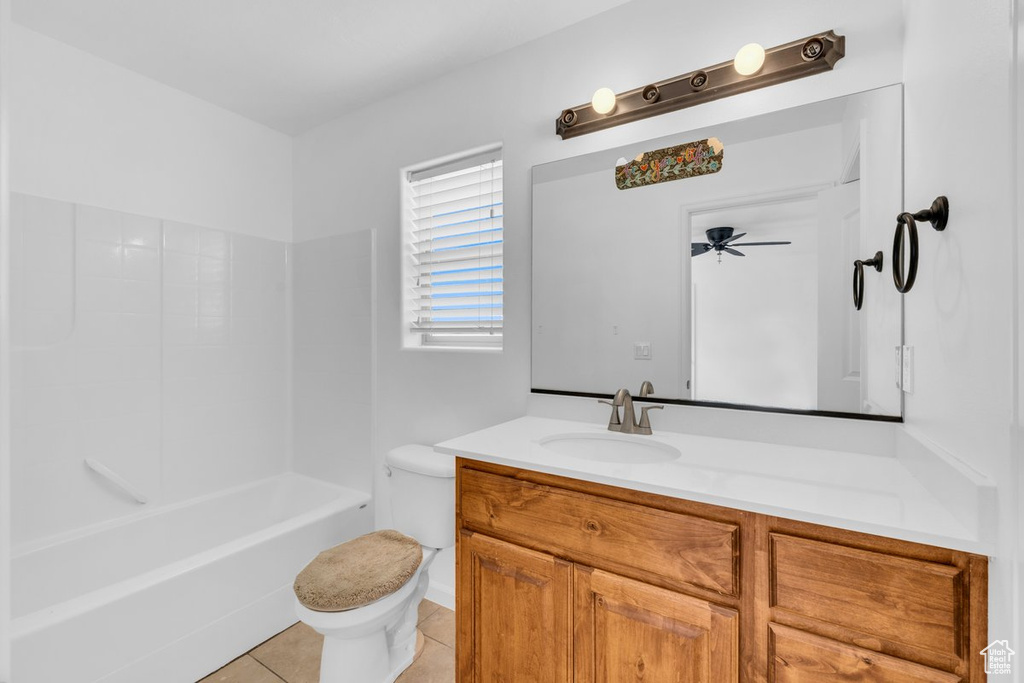 Full bathroom with ceiling fan, toilet, bathtub / shower combination, tile flooring, and vanity