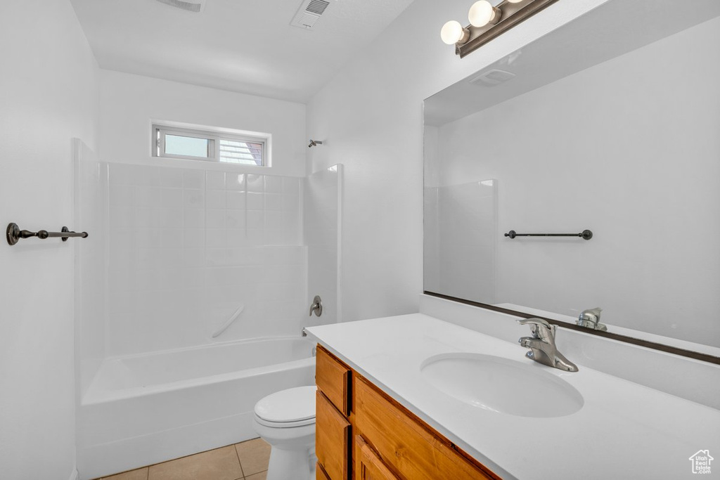 Full bathroom featuring bathtub / shower combination, tile floors, toilet, and vanity