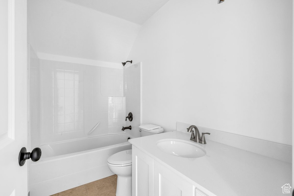Full bathroom with shower / washtub combination, tile floors, lofted ceiling, toilet, and vanity