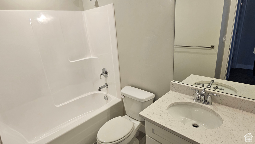 Full bathroom with washtub / shower combination, vanity, and toilet