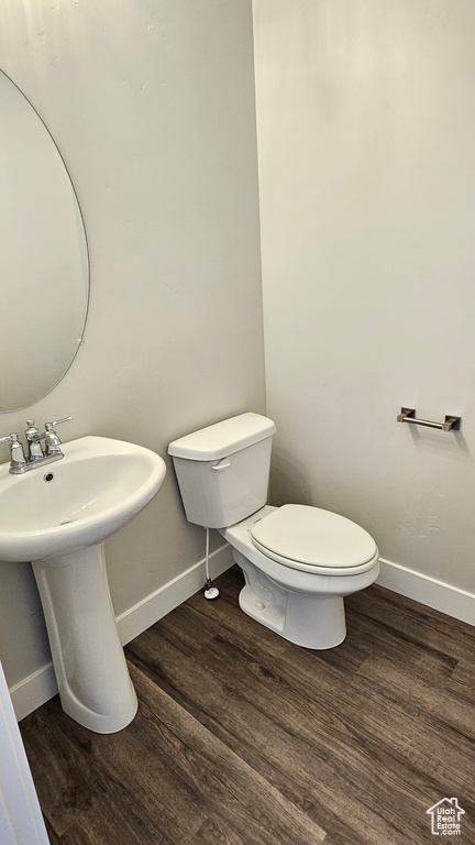 Bathroom featuring hardwood / wood-style floors and toilet