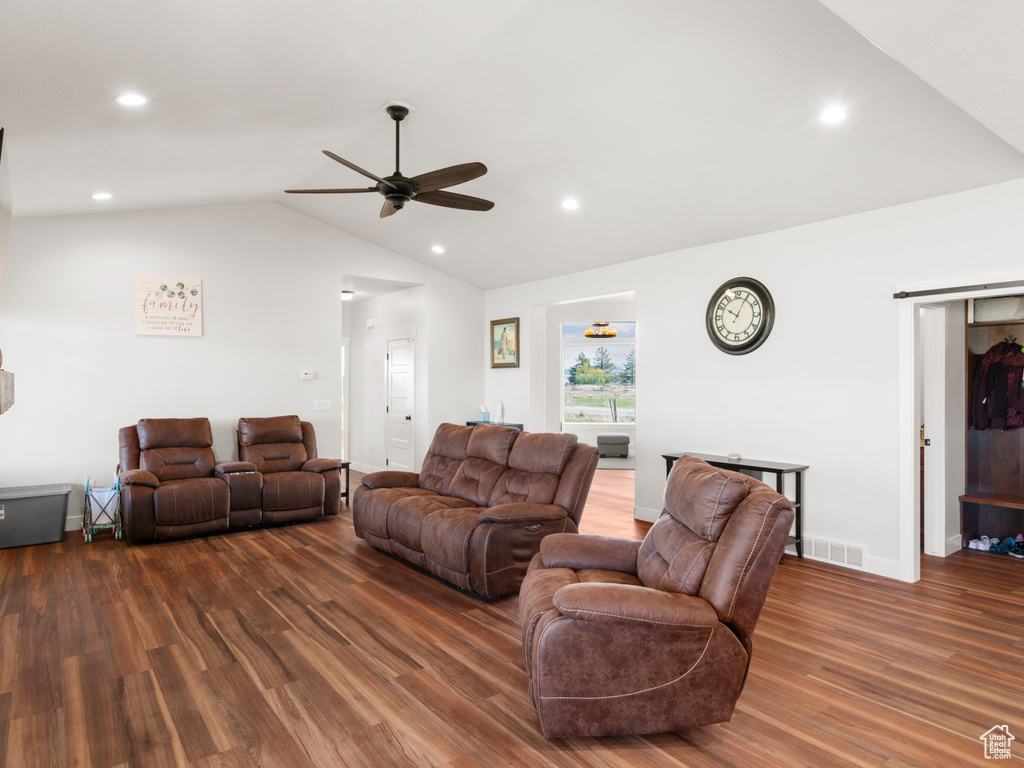 Living room featuring ceiling fan, hardwood / wood-style flooring, and lofted ceiling