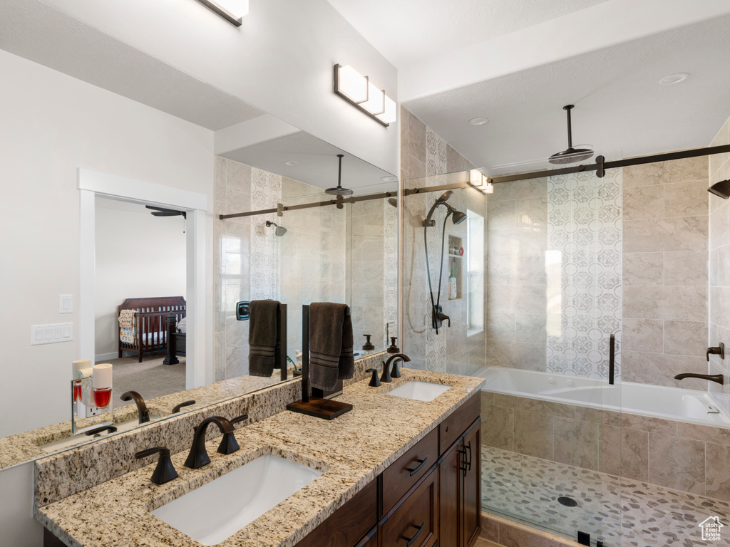 Bathroom with a relaxing tiled bath and dual bowl vanity