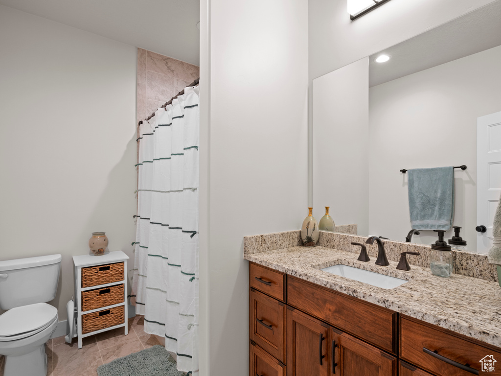 Bathroom featuring tile flooring, toilet, and vanity