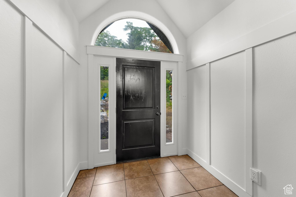 Tiled foyer entrance featuring lofted ceiling and plenty of natural light