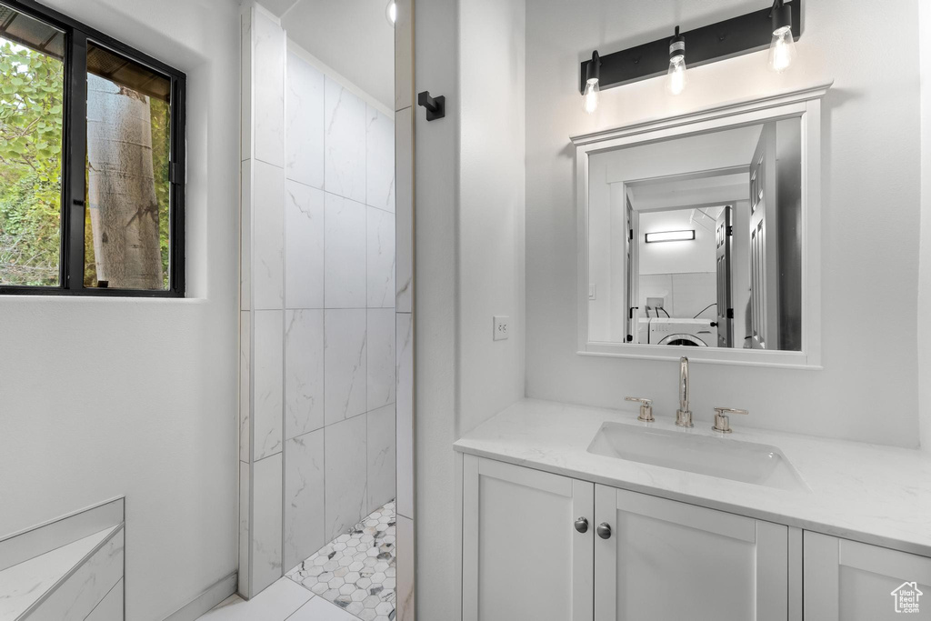Bathroom with a tile shower and oversized vanity