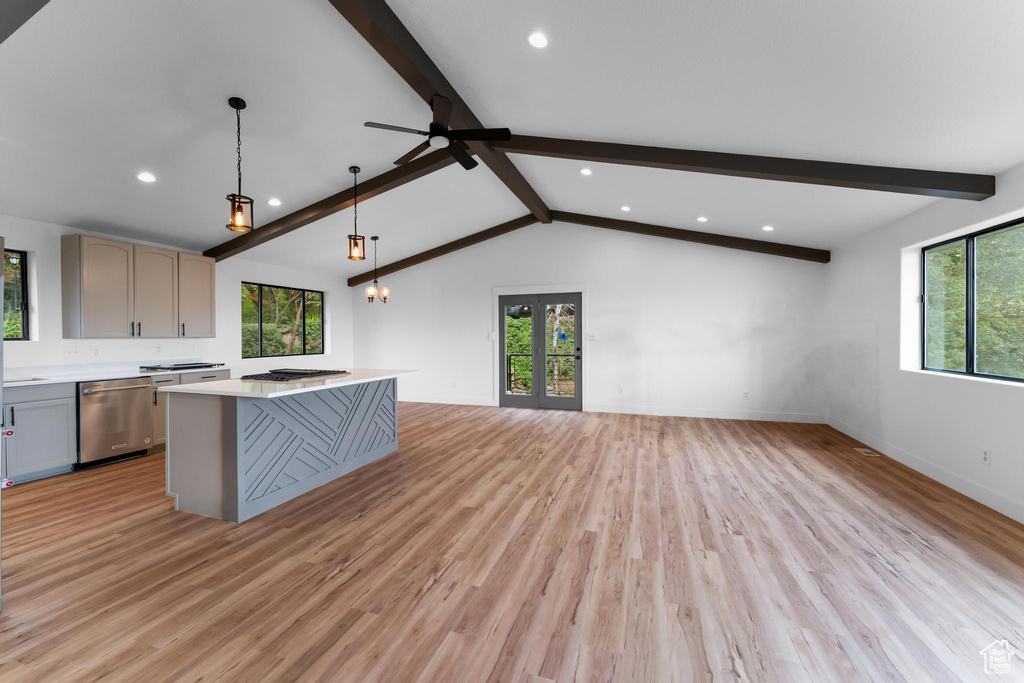 Kitchen featuring a kitchen island, pendant lighting, dishwasher, and light hardwood / wood-style flooring