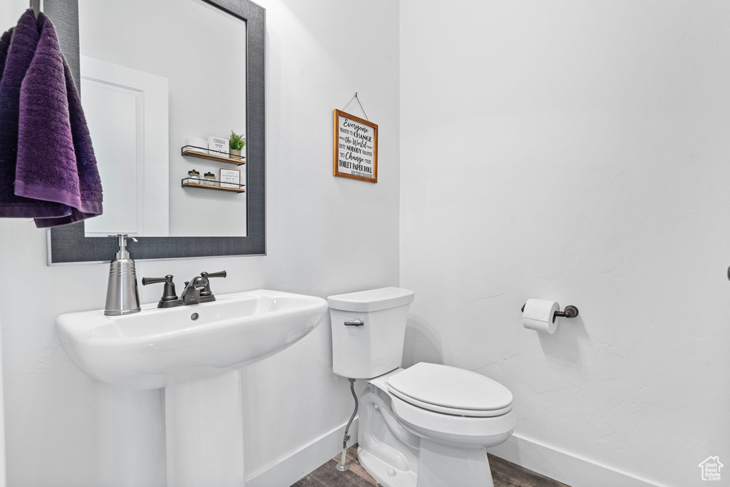 Bathroom with toilet and wood-type flooring