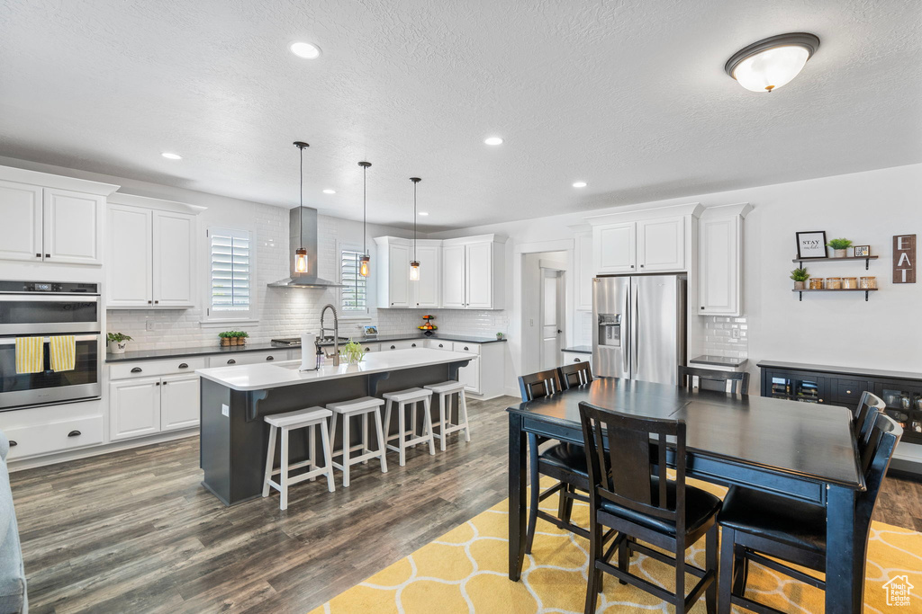 Dining room featuring a textured ceiling and dark wood-type flooring