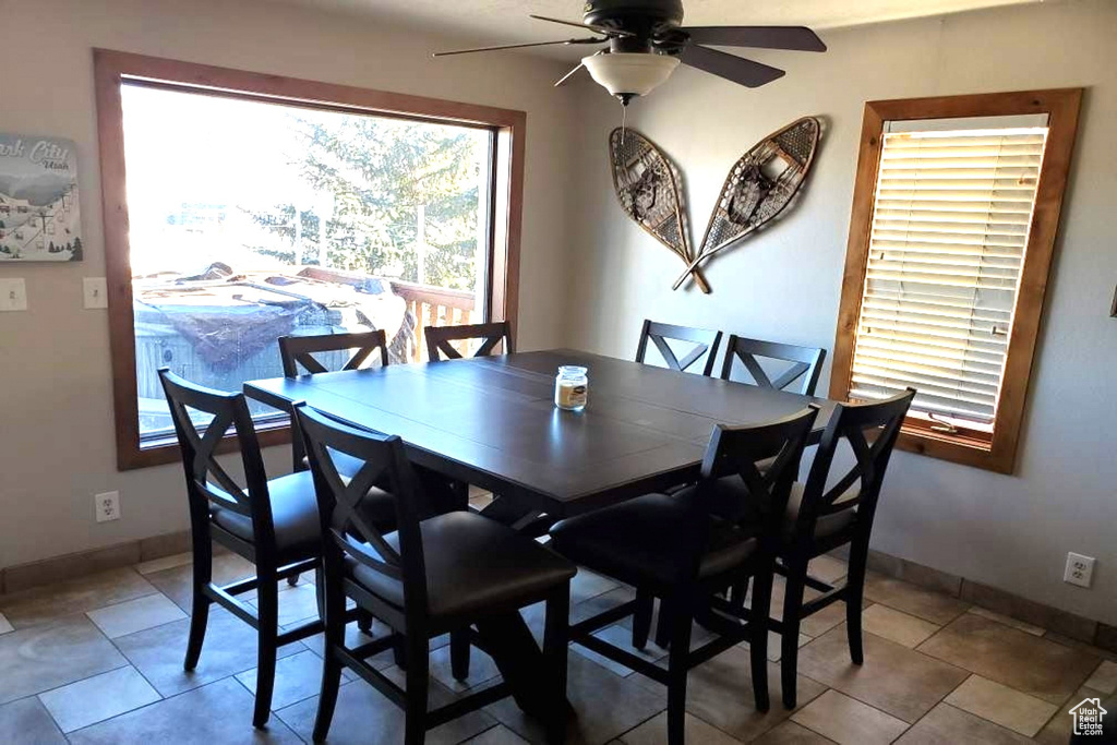 Dining area with ceiling fan and tile floors