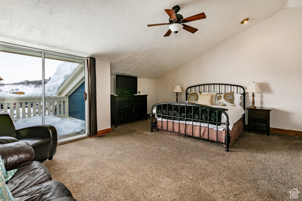 Carpeted bedroom featuring ceiling fan, a textured ceiling, lofted ceiling, and access to exterior